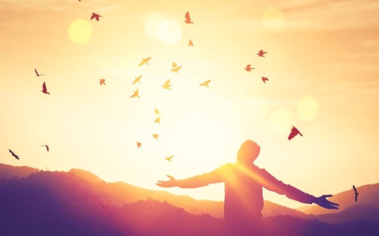 happy_calm_man_birds_mountain_shutterstock-768x480