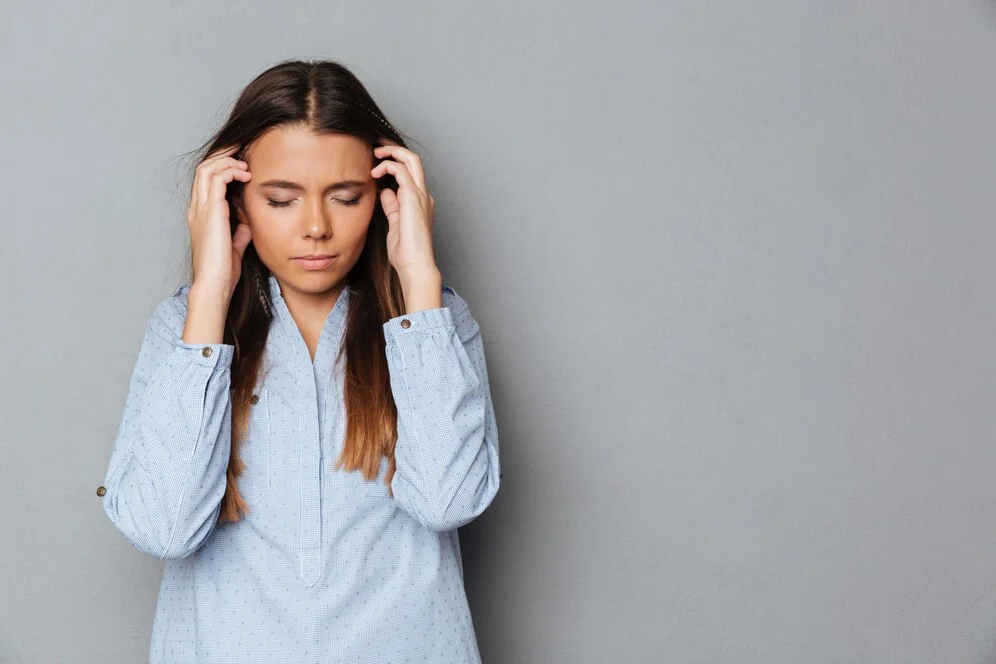 confused-brunette-woman-shirt-with-closed-eyes-having-headache_171337-7504