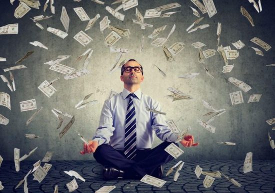 mindset-of-financially-successful-people-man-in-yoga-position-with-money_small-1200x844-550x387-1