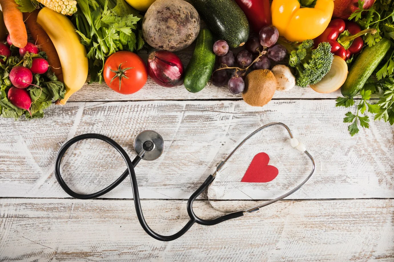 elevated-view-stethoscope-with-heart-shape-near-fresh-vegetables-wooden-desk_23-2147882080