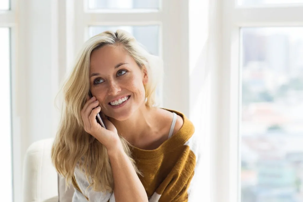 positive-young-woman-talking-mobile-phone