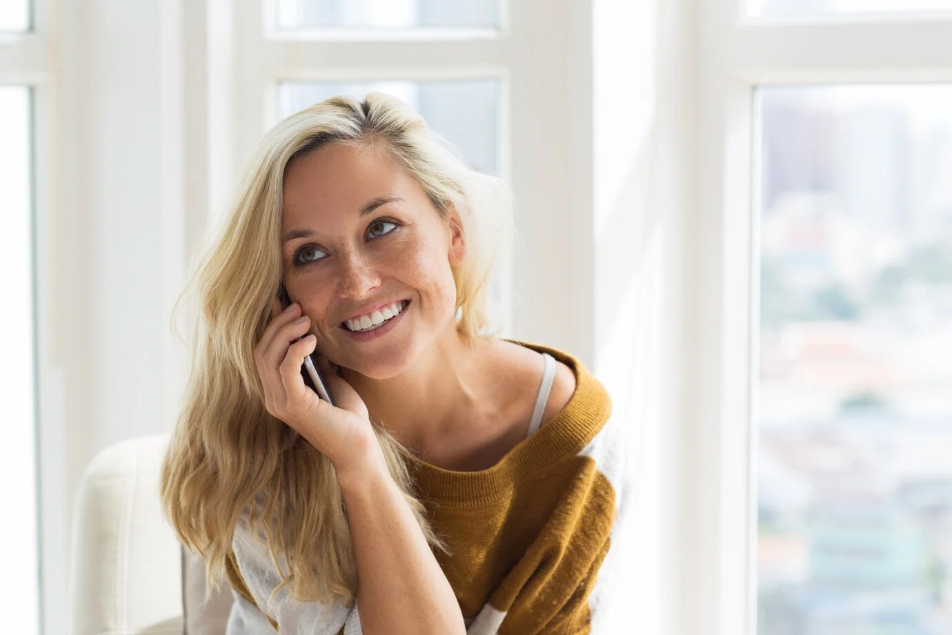 positive-young-woman-talking-mobile-phone