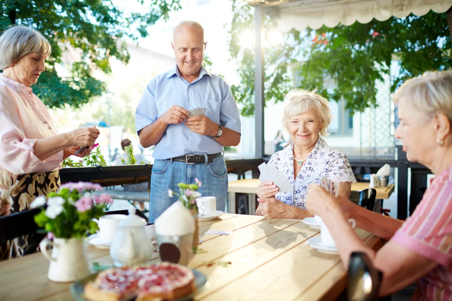 seniors-playing-cards-cafe-scaled