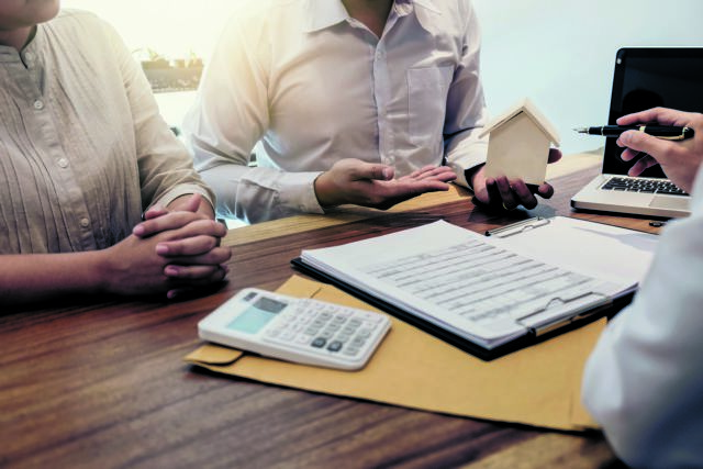 Young couple meeting with a banker for a home loan, Real Estate concept.