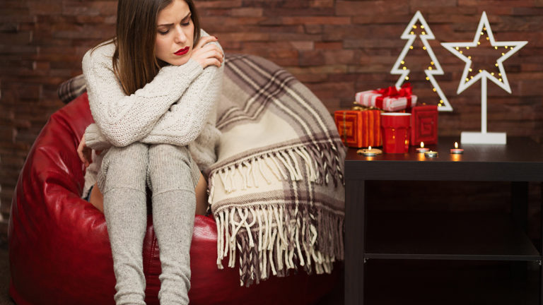 Sad woman with gift boxes