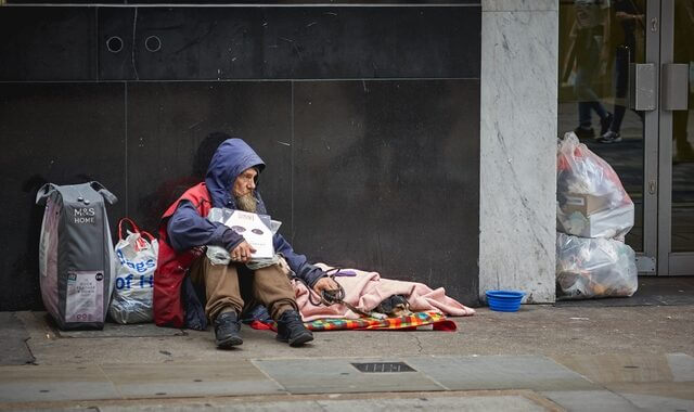 A homeless man begging for help in central London.