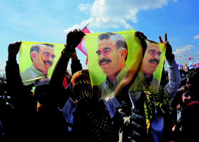 FILE PHOTO: Pro-Kurdish party supporters display flags with portrait of jailed PKK leader Abdullah Ocalan