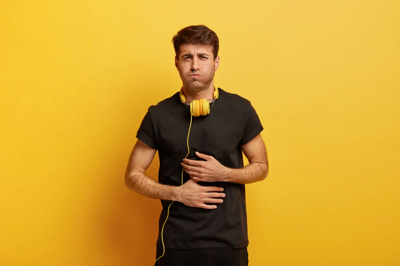 displeased-guy-sufferes-from-bad-feelings-discomfort-stomach-being-sick-scaled