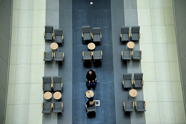 A couple sit in a shopping mall, amid the opposition's call for a mass economy boycott to include a complete halt to shopping, in Instanbul