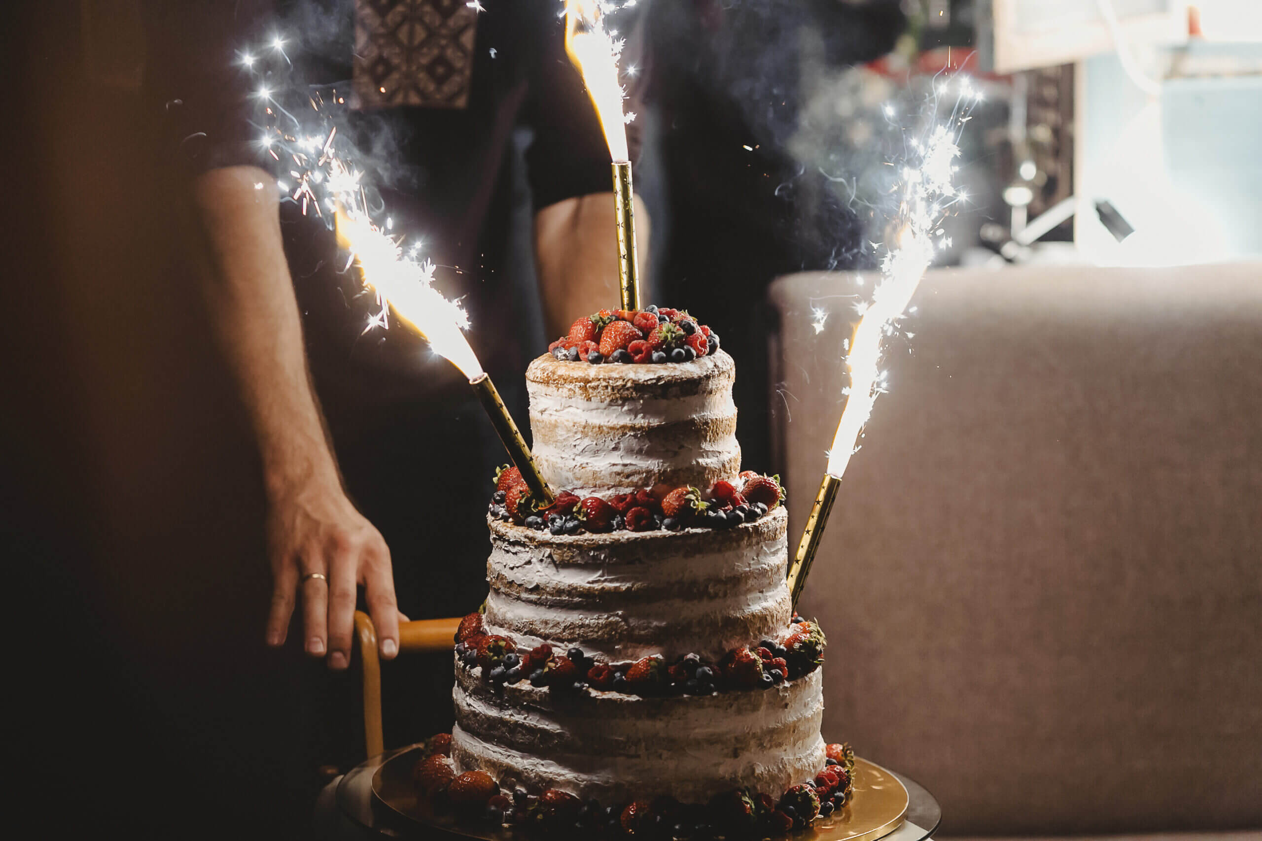 The,Wedding,Cake,With,Fireworks,Stand,On,The,Table,In