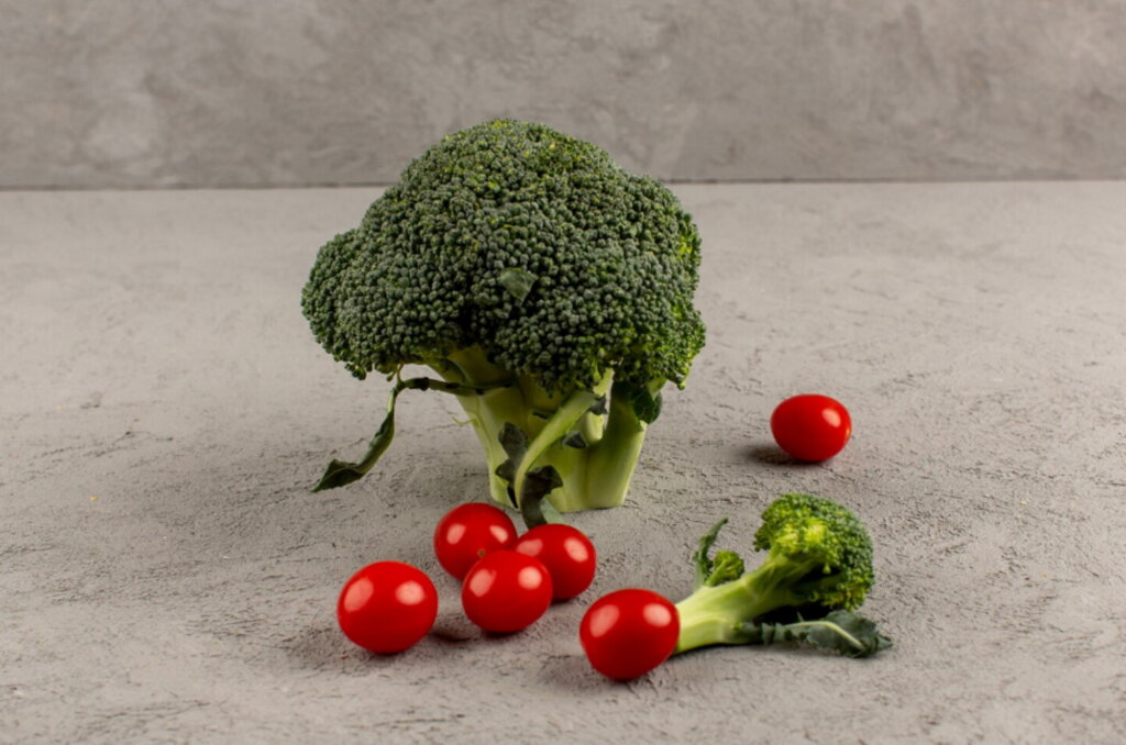 front-view-green-broccoli-fresh-ripe-along-with-red-cherry-tomatoes-isolated-dark-desk-cancer