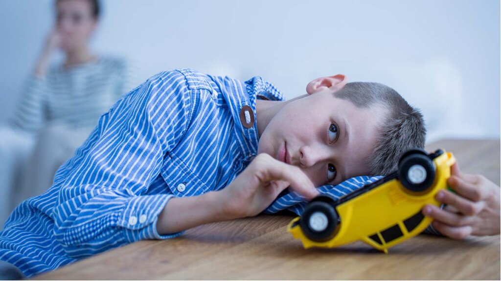 Sad boy with toy car